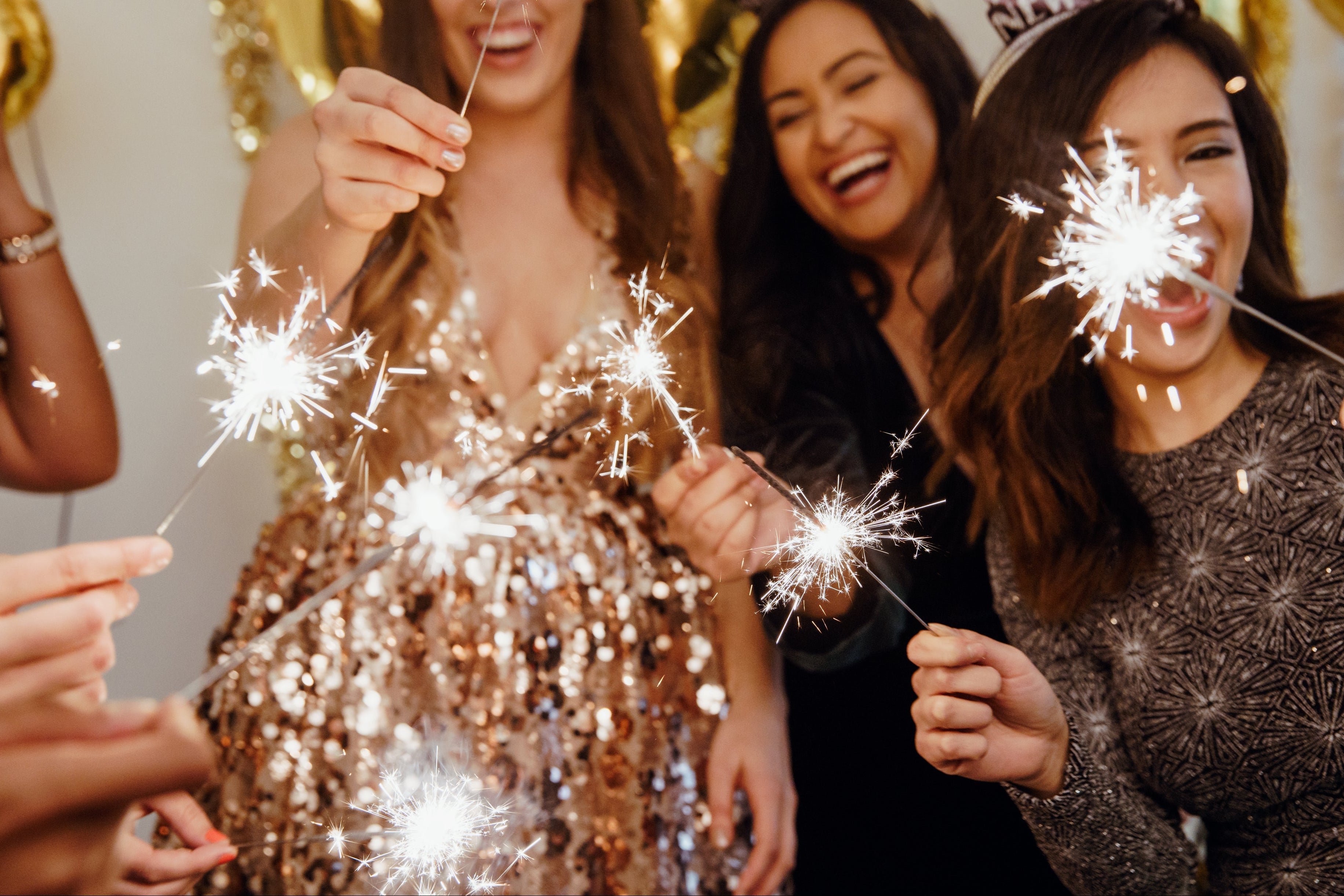 group of girls holding sparklers and laughing