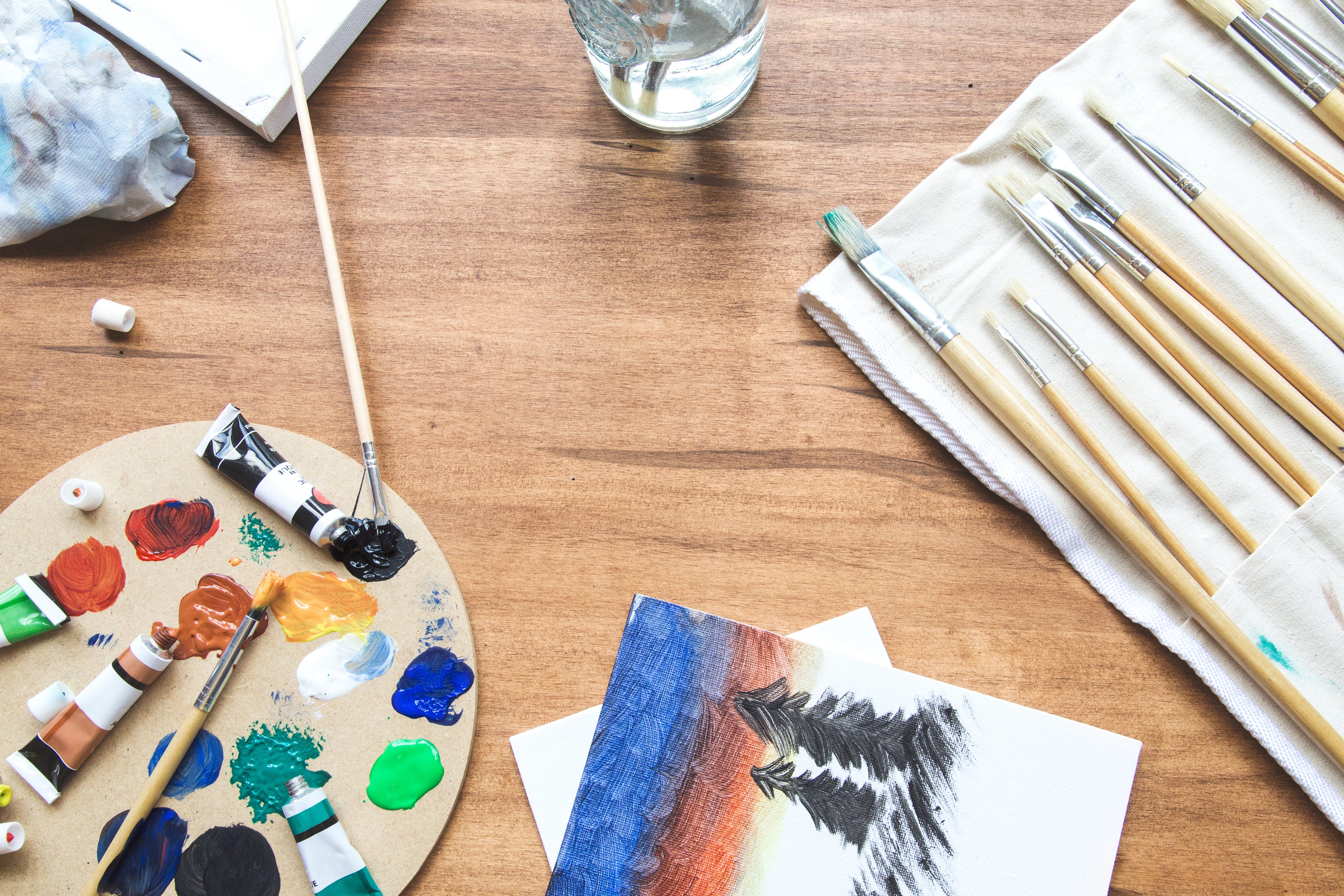 birds eye view of paint pallet and brushes on table